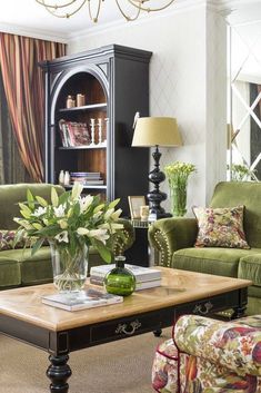 a living room filled with furniture and a chandelier