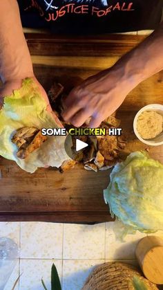 someone is peeling lettuce on top of a wooden cutting board with other food items