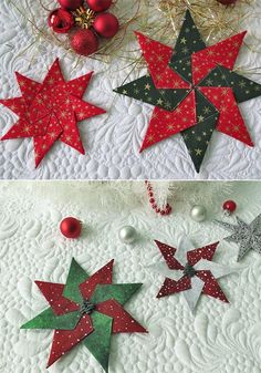 christmas decorations made out of paper stars on a quilted tablecloth with red and green ornaments