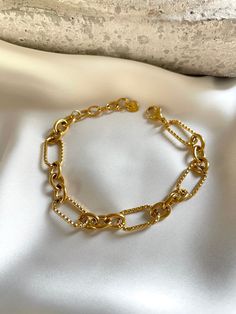 Stunning 18k gold plated bracelet. You can easily style it with every outfit day or evening, casual or occasional. Perfect piece to elevate your look! Made with most durable stainless steel material. So you could enjoy our creations for longest time. M E A S U R E M E N T S Length = 15cm + adjustable extension Chain 5cm; Width = 11mm C A R E T I P S ✔️ Please remove jewelry before showering, swimming and sleeping. ✔️Avoid direct use of perfumes, lotions or other harsh chemicals on the item. ✔️Store in a cool dry place, ideally in a separate compartments to prevent scratching. ✔️Gently wipe jewelry with a polishing cloth to clean and maintain shine. Why jewelry is made from from Stainless steel? Stainless steel ranks 6th on the Mineral Hardness rank, while others such silver ranks at 2.5. T Trendy Adjustable Delicate Chain Bracelet, Trendy Adjustable Gold Bracelet With Delicate Chain, Trendy Metal Chain Bracelet With Delicate Chain, Trendy Delicate Chain Bracelet, Trendy Resizable Gold Jewelry, Trendy Gold Plated Tarnish Resistant Bracelet, Trendy Adjustable Tarnish Resistant Gold Bracelet, Chic Yellow Gold Paperclip Bracelet With Adjustable Chain, Trendy Gold-plated Tarnish-resistant Bracelet