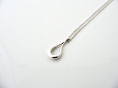 Overview:Offered  for sale is a wonderful Tiffany classic.   Whether you are just  starting your Tiffany collection or are thinking of adding another  piece, this one is perfect for you.  Tiffany & Co.'s Sterling Silver Open Teardrop necklace is a Tiffany classic that will never go  out of style. It will most certainly be a piece that you will turn to  over and over again, so it is great value for your money!  It is a  wonderful necklace that fits a lifestyle on the go -- the necklace can  b Tiffany And Co Necklace, Teardrop Necklace, Stunning Jewellery, Out Of Style, Tiffany & Co., Silver Necklace, Chain, Sterling Silver, Silver