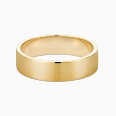 a yellow gold wedding ring on a white background