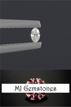 a pink diamond sitting on top of a table next to a pair of tongs