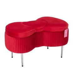 a red bench that is sitting on some metal legs