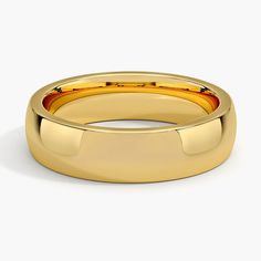 a yellow gold wedding ring on a white background