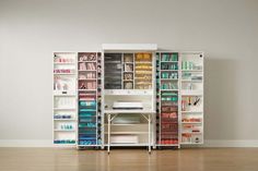 a white bookcase filled with lots of books on top of a hard wood floor