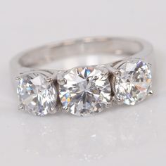 three stone diamond ring on white background