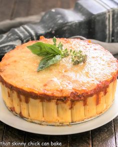 a baked dish with cheese and herbs on a plate