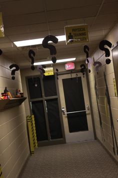 an empty hallway with question marks hanging from the ceiling