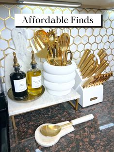 gold kitchen utensils are sitting on a counter