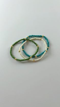 Handmade seed bead bracelet perfect for any occasion! Mini Beaded Bracelets, Casual Turquoise Beaded Bracelets With Tiny Beads, Casual Beaded Bracelet With Gold Beads For Beach, Heishi Beads Bracelets With Gold And Round Beads, Gold Heishi Beads Bracelets, Green Heishi Beaded Colorful Friendship Bracelets, Green Heishi Beaded Bracelet With Letter Beads, Green Heishi Bead Bracelet With Letter Beads, Gold Beaded Bracelets For Beach