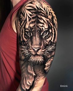 a man with a tiger tattoo on his arm and shoulder, holding onto the arm