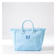 Bold, bright and generously sized, this beach-ready canvas bag has smart details like zipper closure, fringed edging, soft lining, two interior pockets and colors that spark joy. Made by Monogram Mary, from durable canvas, the two-toned embroidered monogram adds a personal touch.  17" w x 10.5" d x 8.5" h  Handle drop: 5"  Three interior pockets. Double open: 9" w x 5" h; Zipper: 7" w x 5.5" h  Canvas.  Spot clean.  Imported.  Monogramming is embroidered   Ships directly from the designer. Ships Blue Fringe Bags For Daily Use, Summer Blue Fringe Bag, Blue Cotton Canvas Bag For Weekend, Blue Fringed Bags For Vacation, Blue Canvas Bags For Weekend, Blue Canvas Weekend Bag, Blue Tote Canvas Bag For The Weekend, Blue Canvas Tote Bag For Weekend, Blue Canvas Bag For Summer