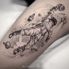 a black and white photo of a person with a tattoo on their leg that is flying through the air