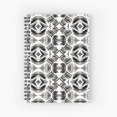 a spiral notebook with black and white designs