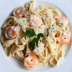 pasta with shrimp and parsley on white plate