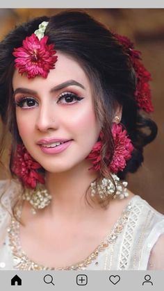 a woman with red flowers in her hair