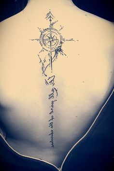 a woman with a compass tattoo on her back