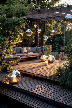 an outdoor living area with couches and lights