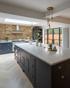 a large kitchen with an island in the middle