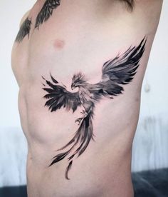 an image of a bird on the side of a man's stomach with tattoos