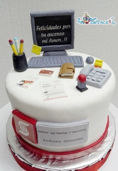 a cake decorated with a computer and other office items on it's top layer