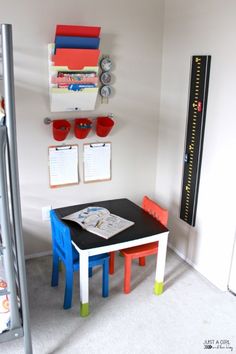 a small table and chairs in a room with white carpeted flooring on the walls