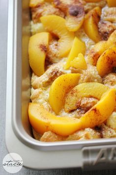 a casserole dish with peaches and cinnamon toppings in a metal pan