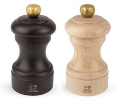 two salt and pepper shakers one is black and the other is wood with gold accents