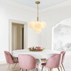 a white table with four pink chairs around it