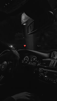 the interior of a car with dashboard lights and steering wheel controls in black and white