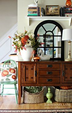 a living room filled with lots of furniture and flowers on top of a wooden table