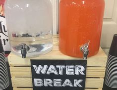 a wooden crate with water bottles on it and a sign that says water break in front of it