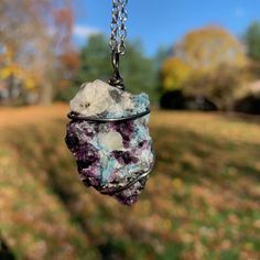 a piece of rock hanging from a chain