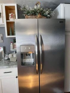 a silver refrigerator freezer sitting inside of a kitchen