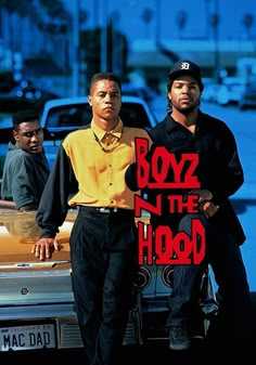 two men standing next to each other in front of a car with the words boyz n the hood on it