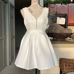 White With Gold Zipper. V-Neck Bust. Open Side Panels. Pleated Skirt That Is Fully Lined. 31 Inches From Shoulder To Hem. 14 Inches From Shoulder To Waist. Waist Is 26.5 Inches Around. No Stretch. 100% Polyester. Fits True To Size. New Without Tags. Never Been Worn. White A-line V-neck Party Dress, White Mini Length V-neck Dress For Cocktail, White V-neck Dress For Night Out In Spring, White V-neck Dress For Spring Night Out, White V-neck Homecoming Dress, Chic V-neck Mini Dress For Homecoming, White Mini Dress For Spring Homecoming, Spring Wedding Mini-length V-neck Dress, White Fitted A-line V-neck Dress