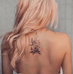 a woman with a rose tattoo on her back