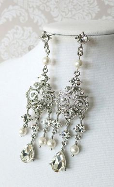 a close up of a necklace on a mannequin with pearls and crystal beads