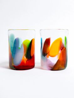 two colorful glass cups sitting next to each other