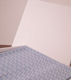 an open box with a blue and white patterned sheet inside