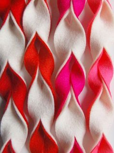 several red and white pieces of fabric with wavy lines on them, all in different colors