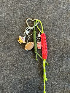 a keychain with some beads attached to it and a football on the end