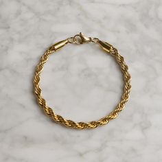 Our minimalist Curb Bracelet is made from Premium quality 316L stainless steel. This allows the chain to be water and sweat resistant. This bracelet can be worn on its own as a statement or be layered with other bracelets. Each bracelet comes with a box. This bracelet boasts a classic rope design, measuring 5mm in width for a bold and stylish look. The chain is sturdy and durable, making it perfect for daily wear or special occasions. With a secure clasp, you can wear it with confidence knowing it will stay in place. This bracelet is versatile enough to complement any outfit, from casual to formal. ♛ DETAILS & MATERIALS ♛ ◈ Bracelet Length:19 cm (7.48 inches) ◈ Bracelet Width: 5 mm ◈ Chain Style: Rope  ◈ Chain Quality: 316L stainless steel with PVD vacuum 18K gold plating ◈ Chain Clasp: Lo Bracelet En Cuir Diy, Bracelet For Men Gold, Bracelet For Man, Rope Bracelet Men, Molecule Necklace, Mens Chain, Diy Leather Bracelet, Mens Chain Bracelet, Mens Valentines Gifts