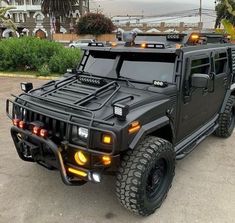 a black hummer truck parked in a parking lot