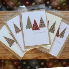 five christmas cards with small trees on them