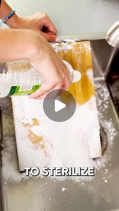 a person is washing dishes in a sink