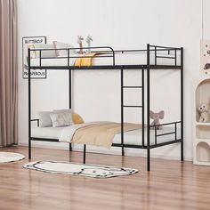 a black metal bunk bed sitting on top of a hard wood floor next to a white wall