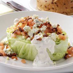 a white plate topped with lettuce covered in ranch dressing