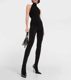 An easy elegance underpins Norma Kamali's catsuit. Made for a close fit, this halterneck style has an open back and stirrup feet..Made in China.Material: 5% elastane, 95% polyester.Care instructions: machine wash cold.Designer color name: Black.True to size.Low back.Fitted.Mid-weight material.Stretchy fabric.Skinny leg.The model seen in the picture is 178cm-5'10' and wearing a size XS Sleek Sleeveless Fitted Unitard, Sleek Fitted Sleeveless Unitard, Stretch Halter Neck Bodysuit For Evening, Elegant Fitted High Neck Jumpsuit, Elegant Stretch Unitard, Fitted High Neck Jumpsuit For Evening, Chic Fitted Full-length Bodysuit, Chic Fitted Full Length Bodysuit, Elegant Fitted Unitard For Evening